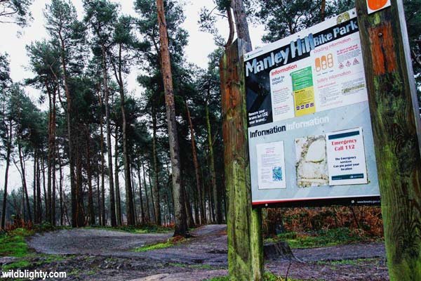 Manley Hill Bike Park sign with trails beyond